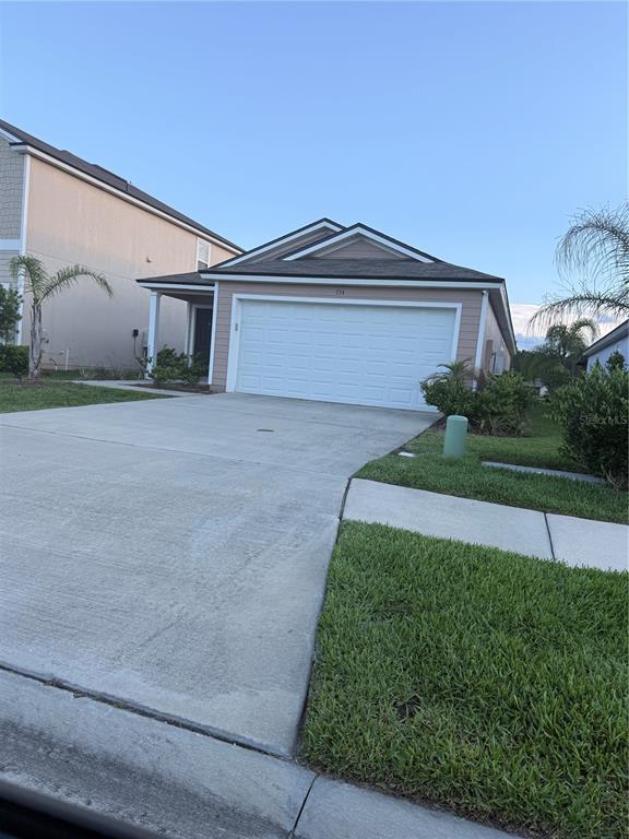 A single-story house with a white garage door and a concrete driveway — 754 GRAND RESERVE DRIVE, BUNNELL, FL