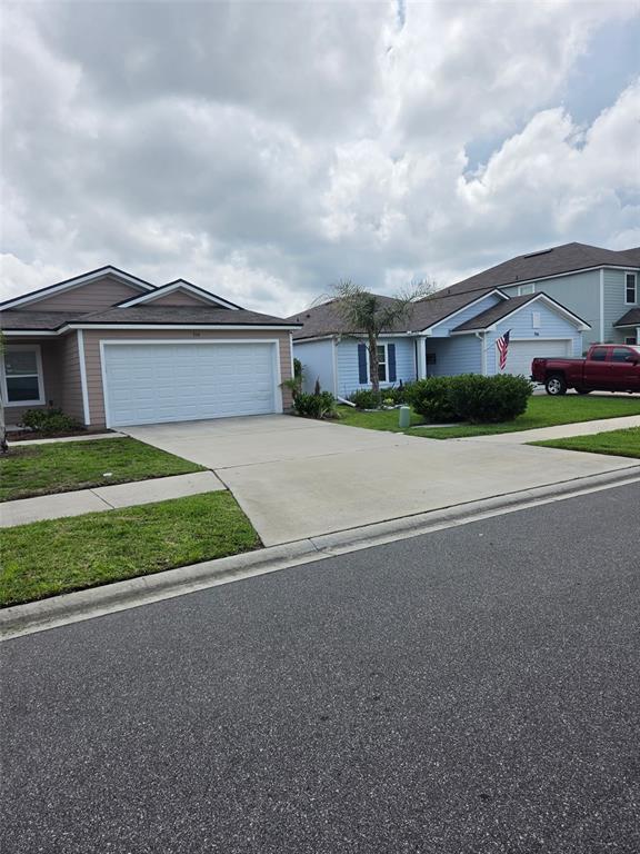 A street view of two suburban houses with driveways and a red pickup truck — 754 GRAND RESERVE DRIVE, BUNNELL, FL