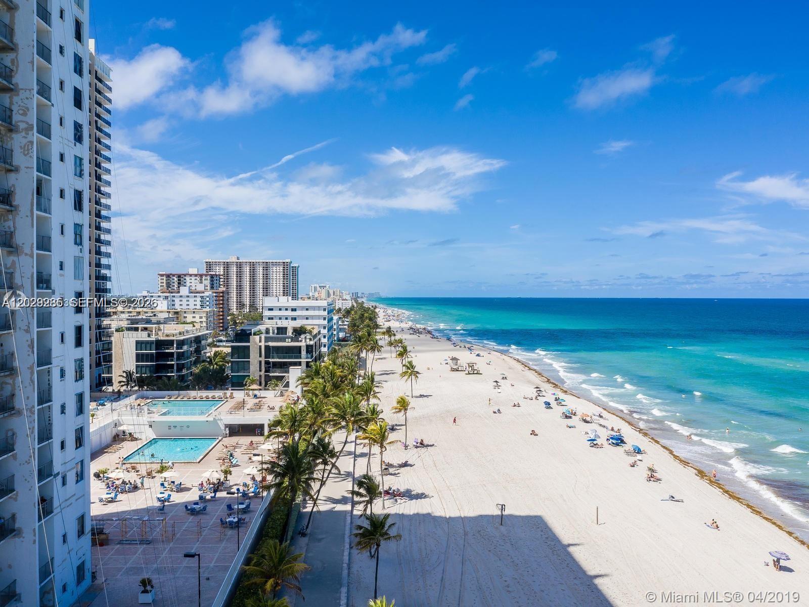 An aerial view of a beach, ocean, and high-rise buildings with swimming pools — 2101 S Ocean Dr # 306, Hollywood FL 33019, HOLLYWOOD, FL