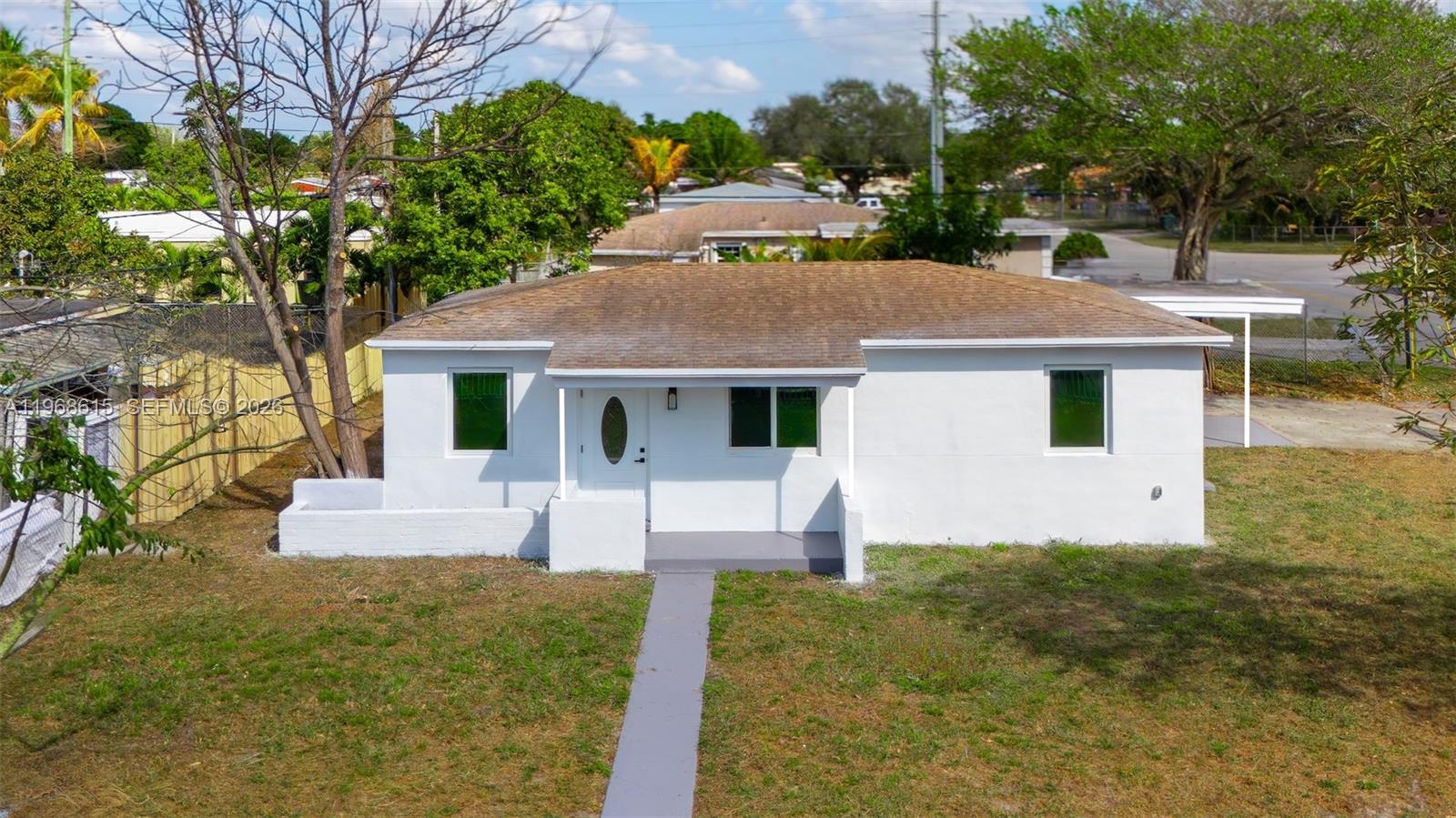 A single-story white house with a brown shingled roof and a front walkway — 1735 NW 126th St, Miami FL 33167, MIAMI, FL