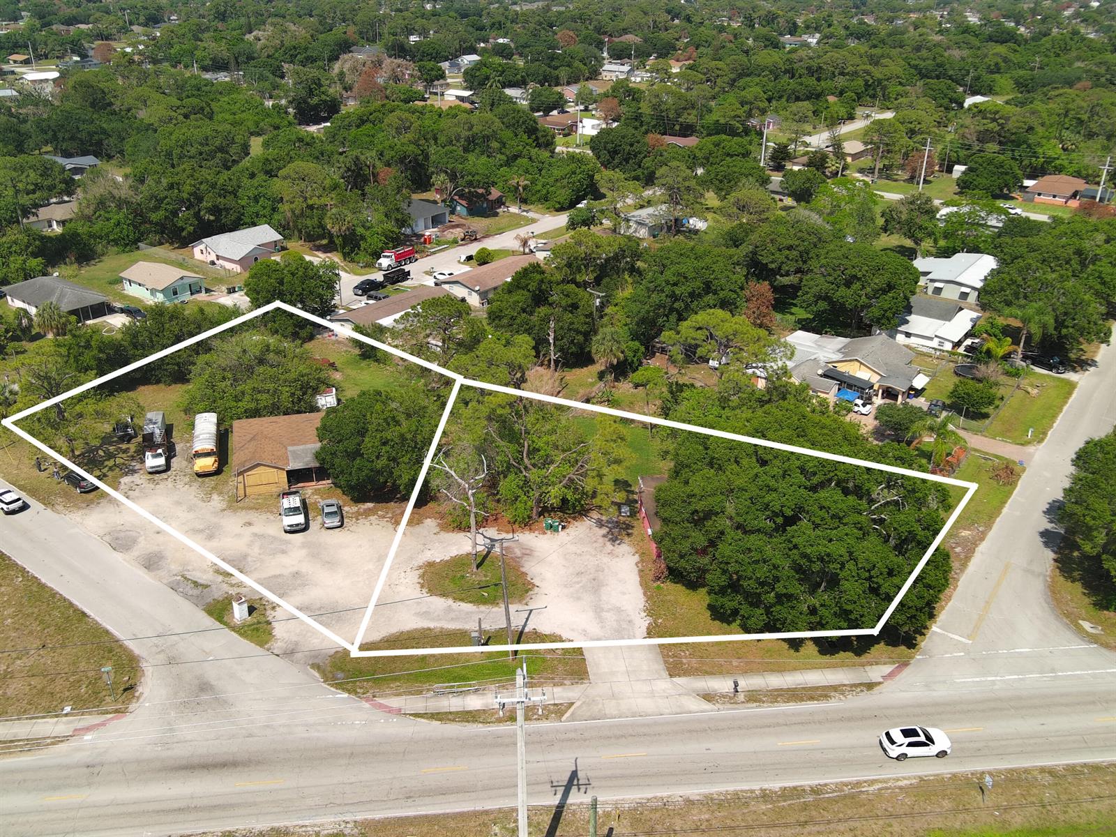 An aerial view shows two adjacent lots with a house, parking areas, and mature trees — 902 Angle Road, Fort Pierce FL 34947, FORT PIERCE, FL