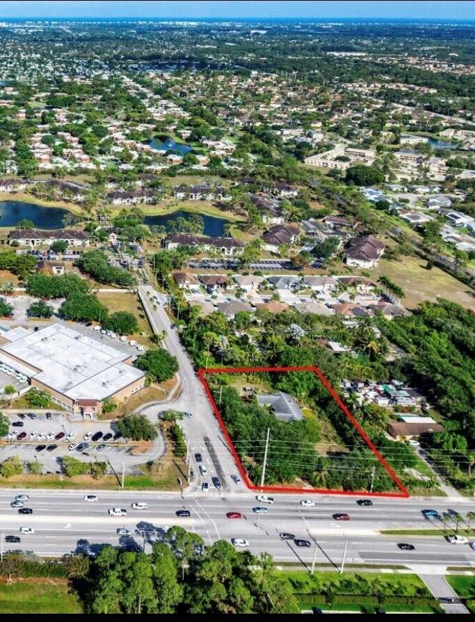 An aerial view shows a rectangular residential lot outlined in red next to a road — 4390 S Jog Road, FL 33463, FL