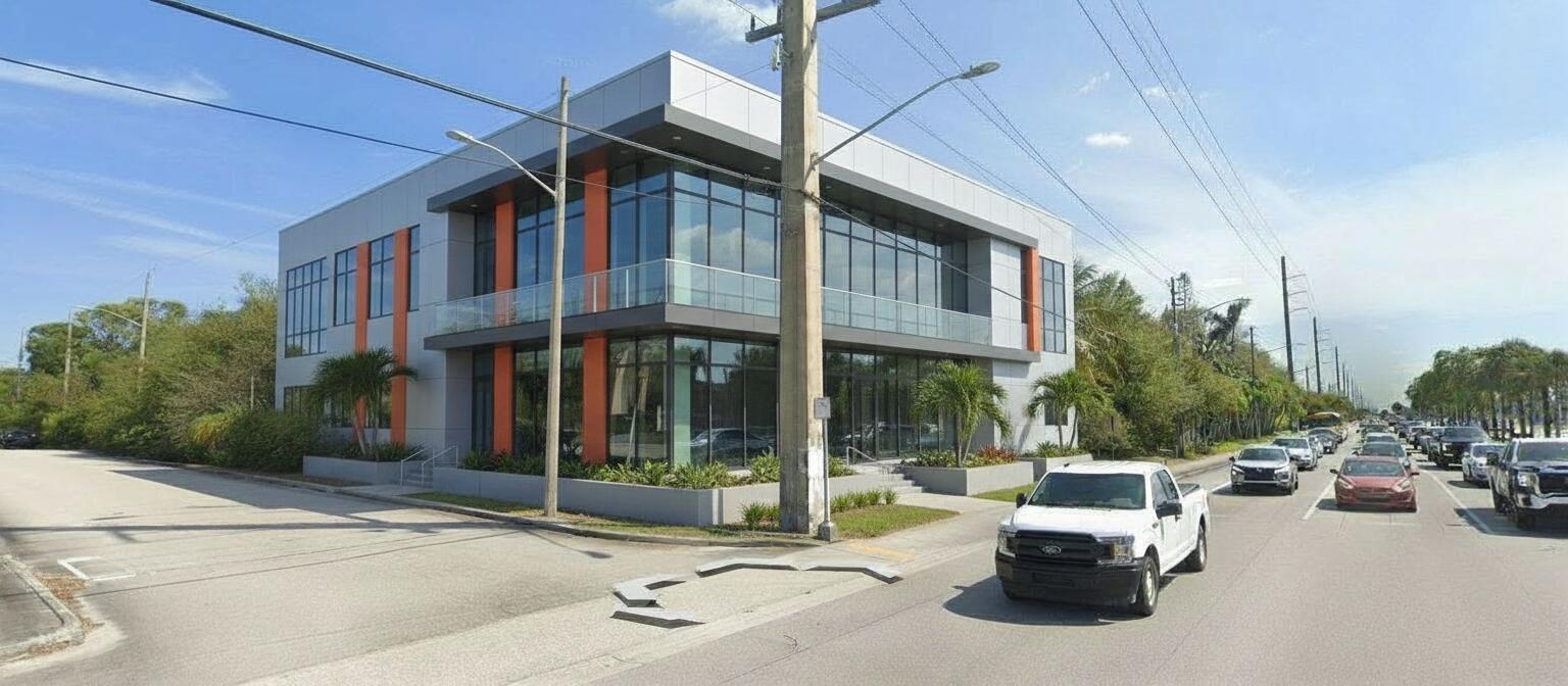 A modern two-story office building with glass windows, orange accents, and a balcony — 4390 S Jog Road, FL 33463, FL