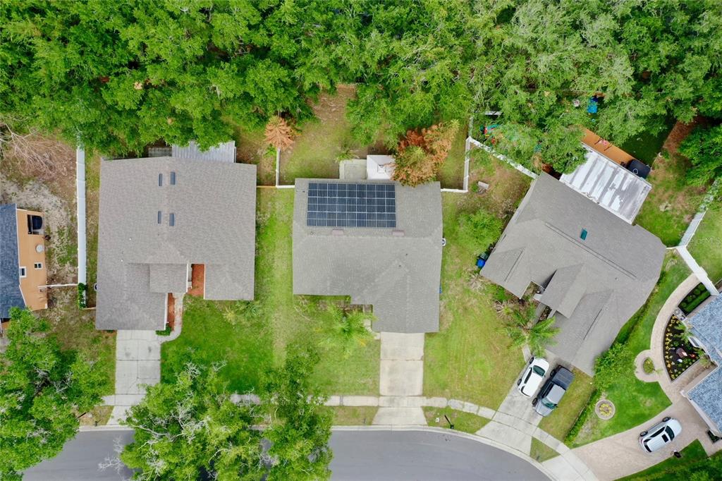An aerial view shows three suburban houses with driveways and lawns surrounded by dense trees — 319 STERLING LAKE DRIVE, OCOEE, FL