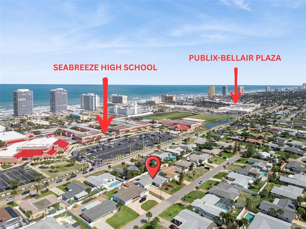 This aerial view shows a residential neighborhood near a high school and a shopping plaza — 3050 PRINCETON AVENUE, DAYTONA BEACH, FL