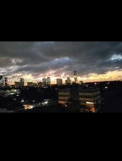 An elevated view of a city skyline at sunset under a cloudy sky — 2950 SW 3rd Ave # 3A, Miami FL 33129, MIAMI, FL