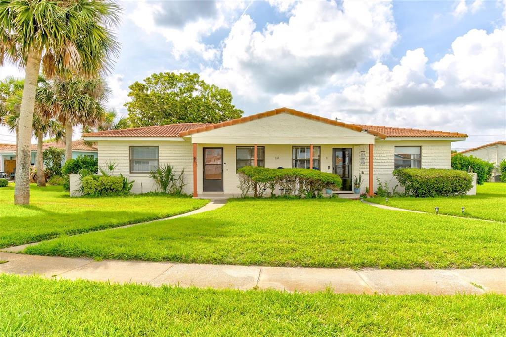 A single-story house with a light-colored exterior, a tiled roof, and a front lawn — 232 NORTHSHORE DRIVE UNIT A, ORMOND BEACH, FL