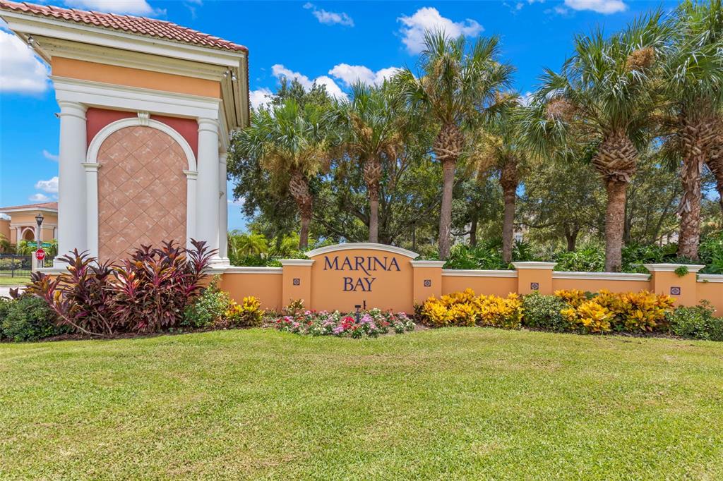 A stone entrance sign for Marina Bay stands in front of palm trees and landscaping — 6 ACADEMY WAY S UNIT 221, ST PETERSBURG, FL