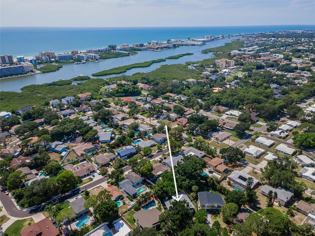 An aerial view of a residential neighborhood near a coastal waterway with a marked house — 14279 85TH AVENUE, SEMINOLE, FL