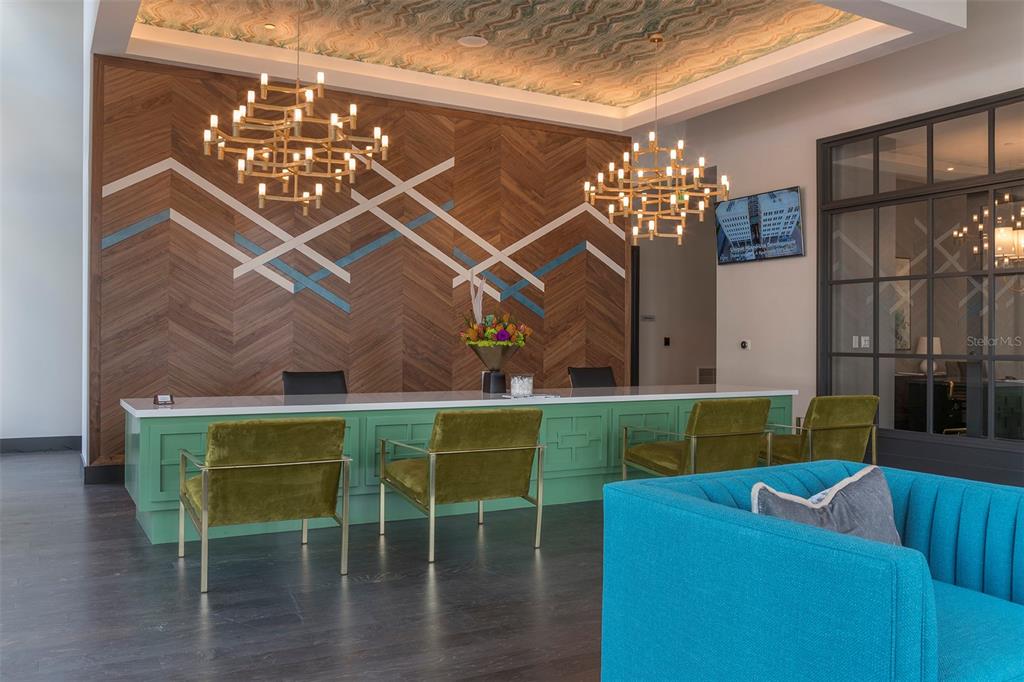 A reception area features a green desk, velvet chairs, wood-paneled wall, and two gold chandeliers — 733 MAIN LANE UNIT 2, ORLANDO, FL