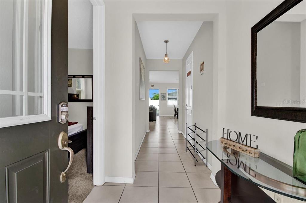 A tiled entryway leads to a hallway with a view into a living area — 9021 FLAMINGO KEY WAY, KISSIMMEE, FL