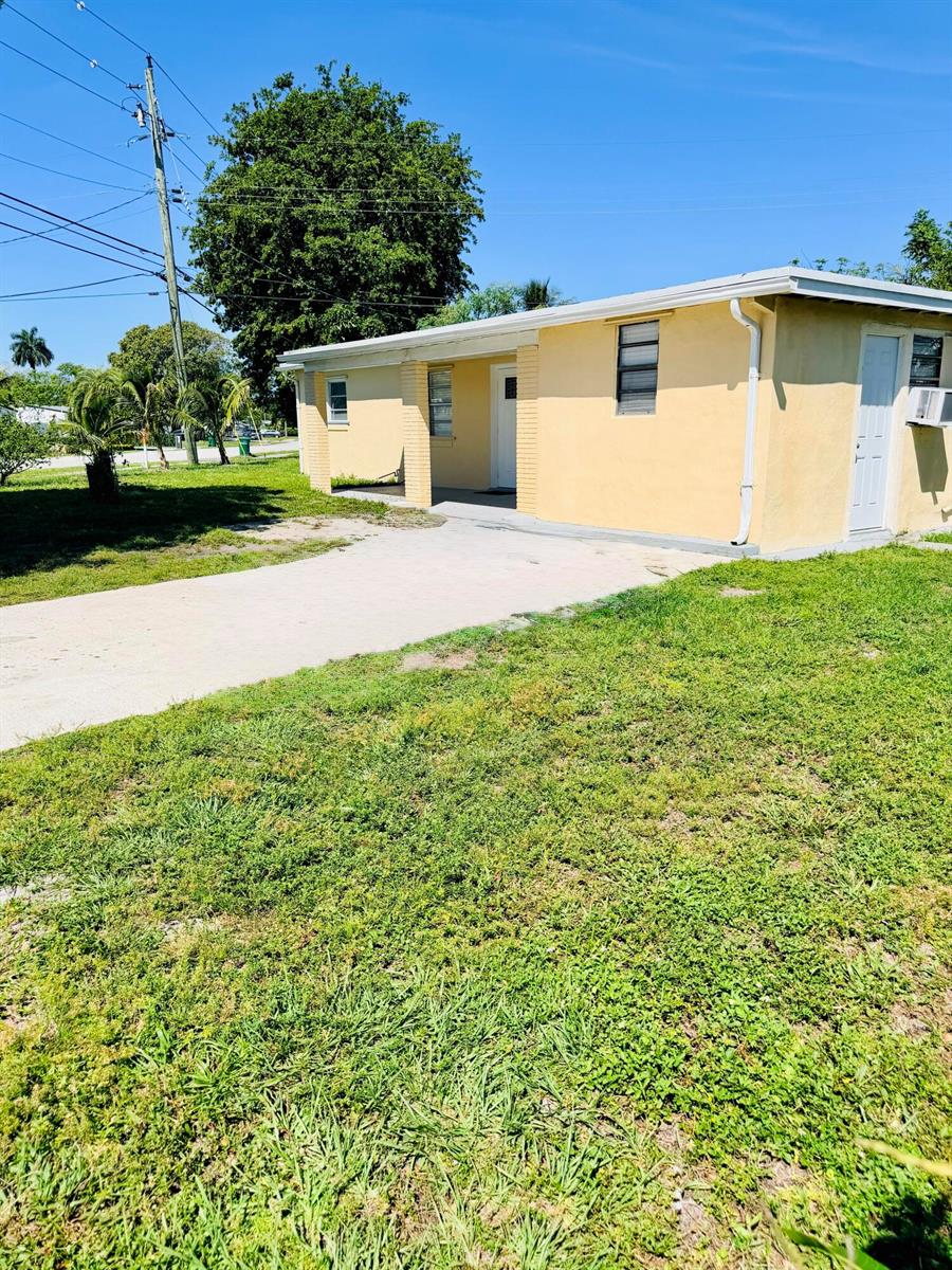 A single-story yellow house with a concrete driveway and a small front porch — 5755 Winfield Boulevard, Margate FL 33063, MARGATE, FL
