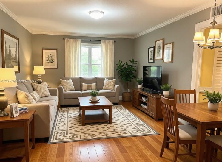 A living room features a sofa, coffee table, television, and dining area with hardwood floors — 1750 W 46th St # 0, Hialeah FL 33012, HIALEAH, FL