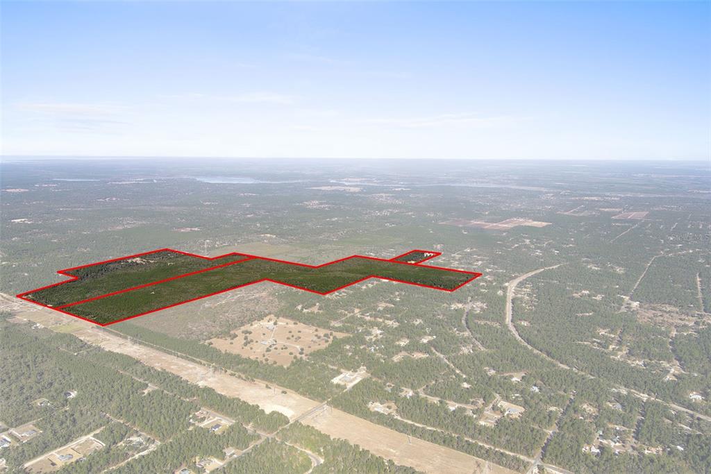 An aerial view shows a large, irregularly shaped plot of land outlined in red — 5030 W DUNKLIN STREET, CITRUS SPRINGS, FL