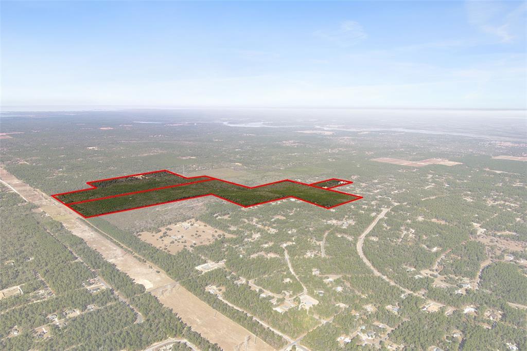 An aerial view shows a large, wooded plot of land outlined in red — 5030 W DUNKLIN STREET, CITRUS SPRINGS, FL