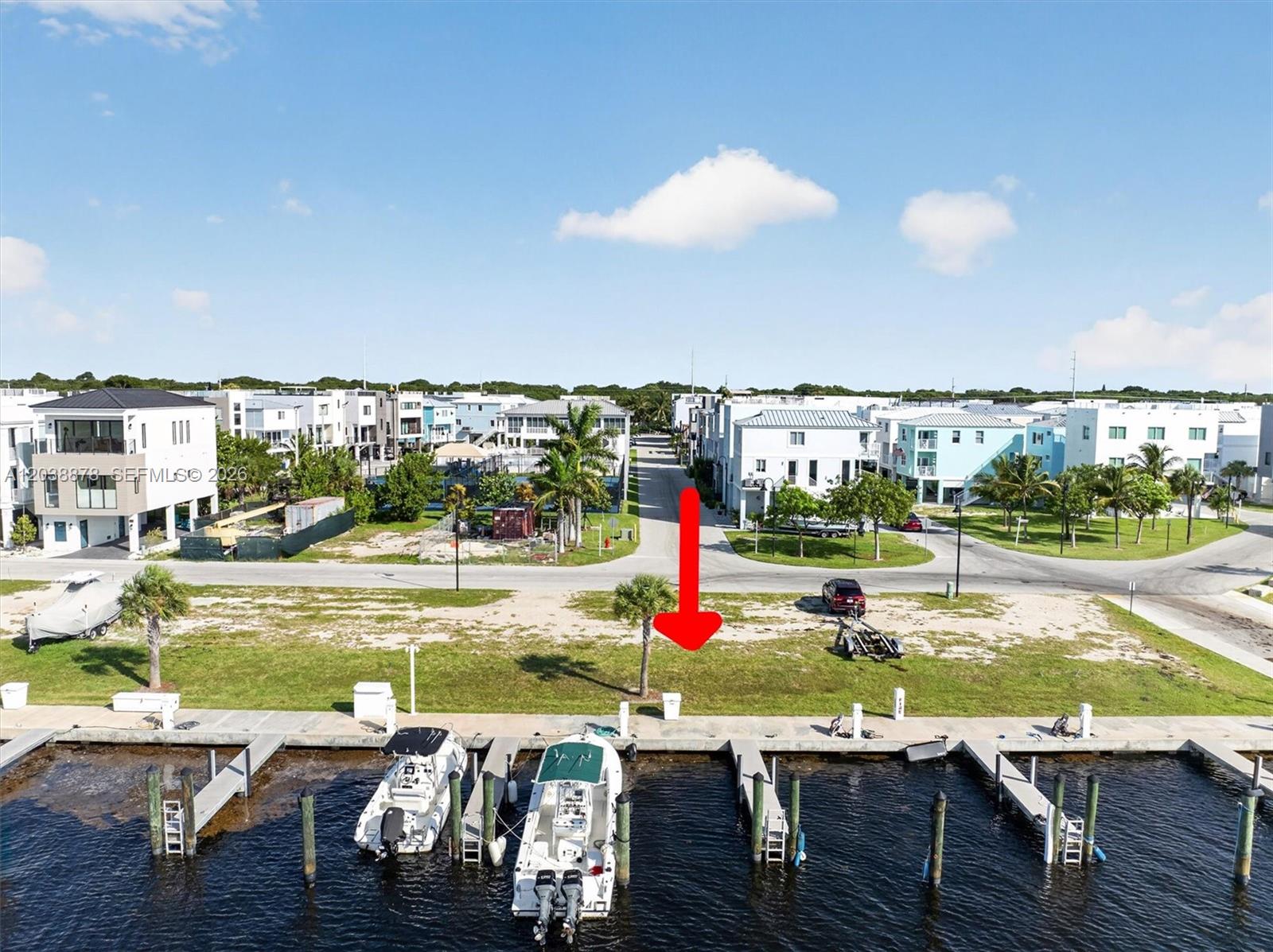 An aerial view shows a vacant waterfront lot with a boat dock and slips — 94825 OVERSEAS HIGHWAY #123, Key Largo FL 33037, KEY LARGO, FL