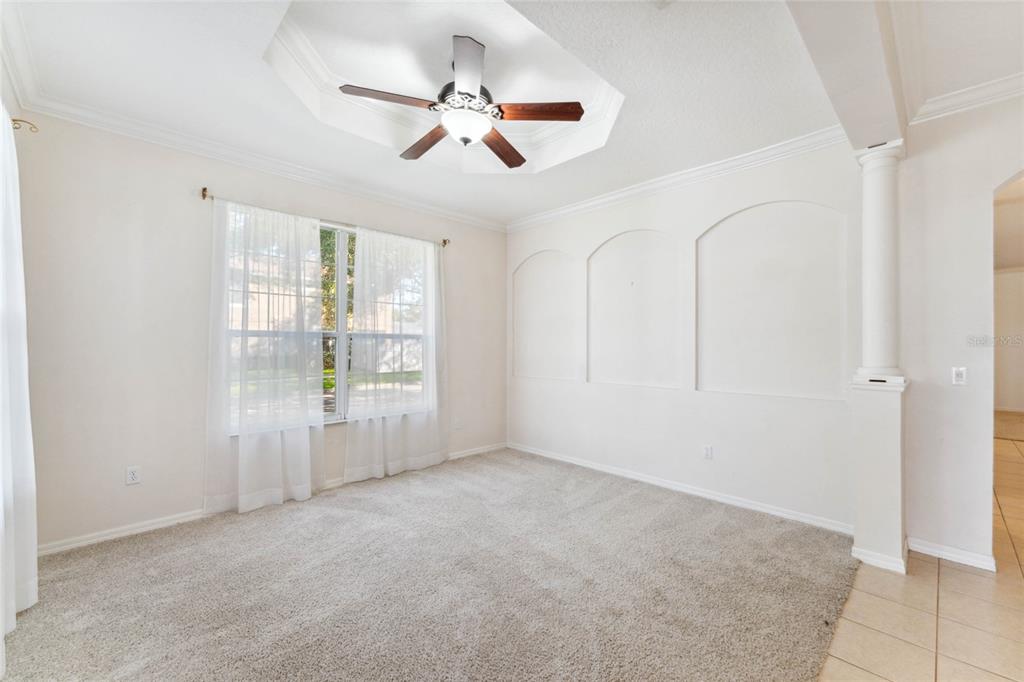 A carpeted room features a tray ceiling with a fan and three arched wall niches — 5007 RIVER GEM AVENUE, WINDERMERE, FL