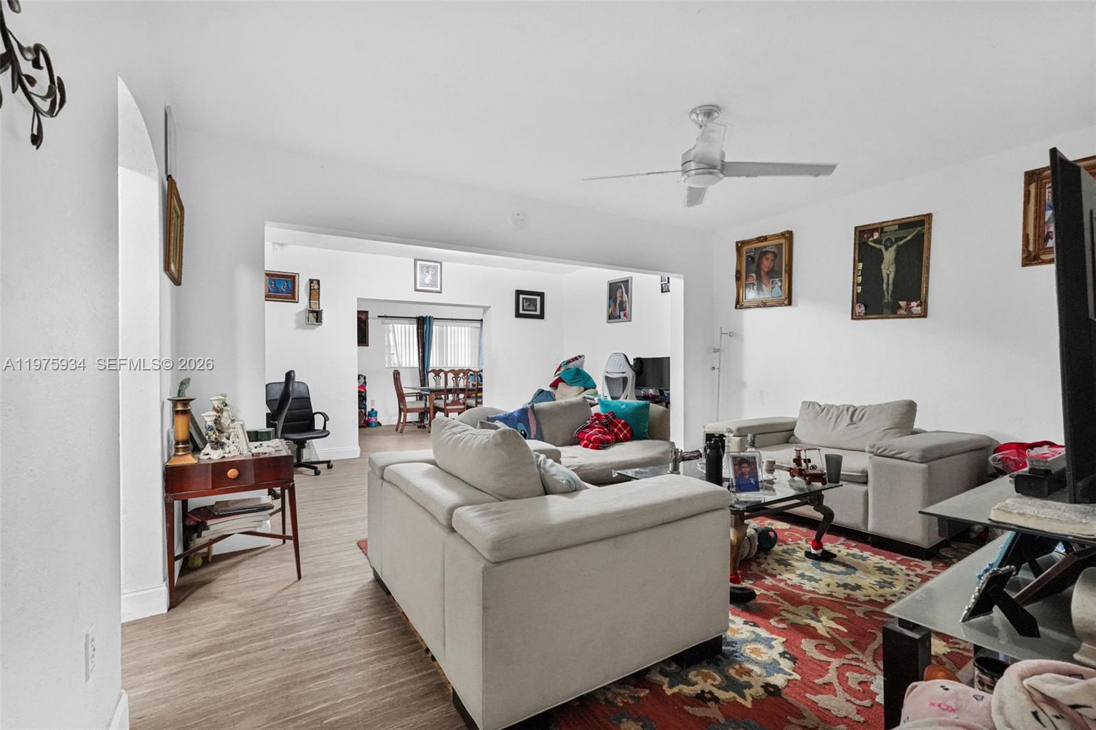A living room features light-colored sofas, a patterned area rug, and a ceiling fan — 538 NW 20th Ave, Miami FL 33125, MIAMI, FL