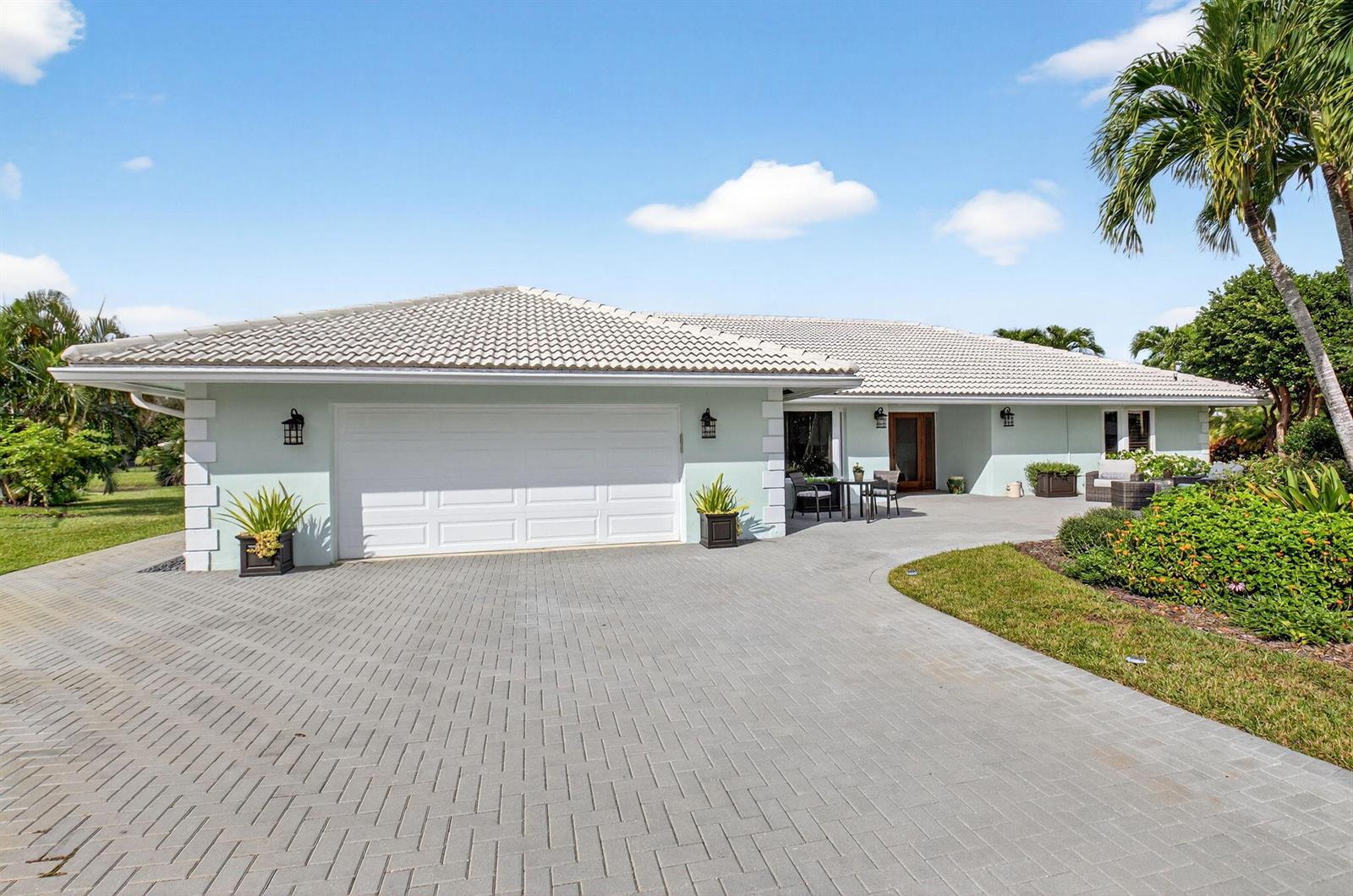 A light green single-story house with a white tile roof and a paved driveway — 11949 Date Palm Drive, Boynton Beach FL 33436, BOYNTON BEACH, FL