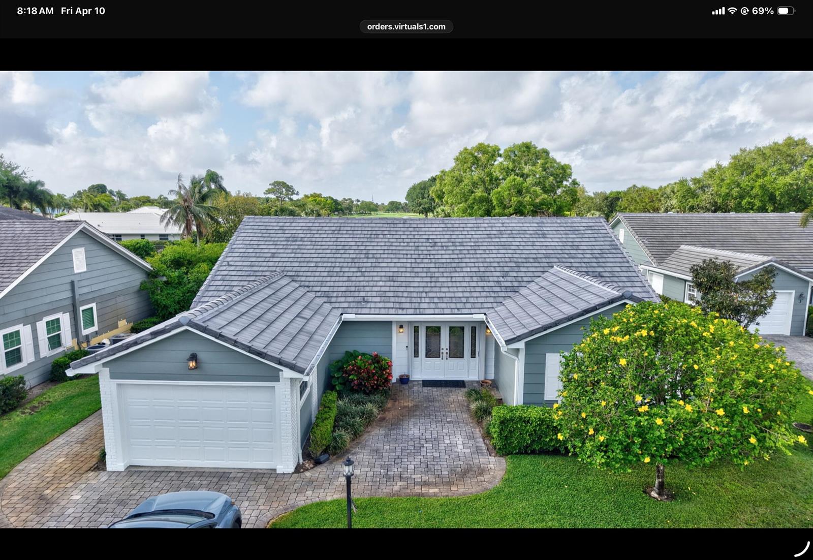 An aerial view of a single-story house with a gray tile roof and paver driveway — 2 Holly Drive, Boynton Beach FL 33436, BOYNTON BEACH, FL