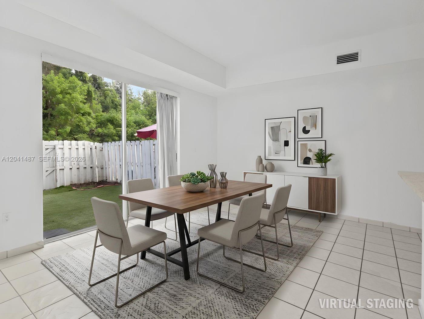 A dining room with a wooden table, six chairs, and a sliding door to a patio — 10966 NW 43rd Ter # 10966, Doral FL 33178, DORAL, FL