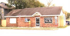 A single-story brick building with a gabled roof serves as a barber shop — 414 W OAK RIDGE ROAD, ORLANDO, FL