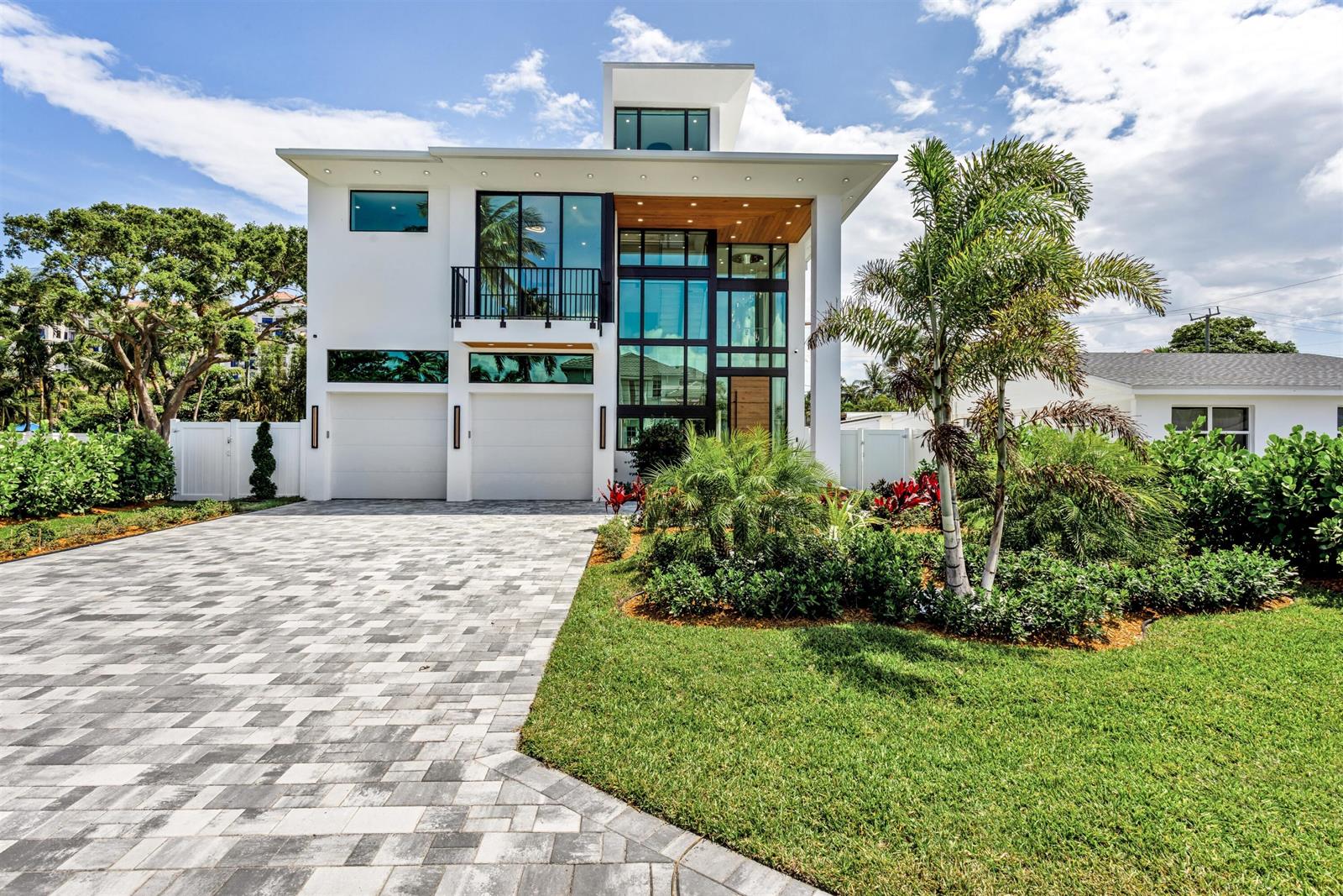 A modern two-story house with a paved driveway, large glass windows, and a palm tree — 310 NE 2nd Street, Boca Raton FL 33432, BOCA RATON, FL