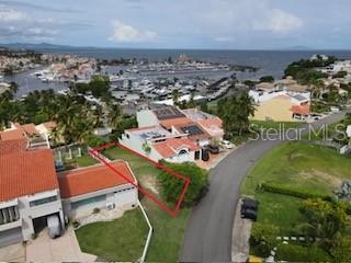 An aerial view shows a residential house with a red roof near a marina — HARBOUR VIEW UNIT 10, HUMACAO, PR