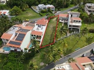 An aerial view shows a vacant rectangular lot situated between two multi-story residential buildings — HARBOUR VIEW UNIT 10, HUMACAO, PR