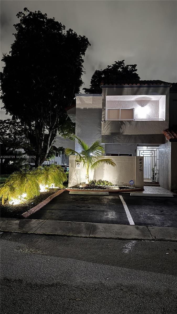 A two-story townhouse exterior features a paved parking space, palm trees, and a gated entrance — 6475 SW 129th Ave, Miami FL 33183, MIAMI, FL