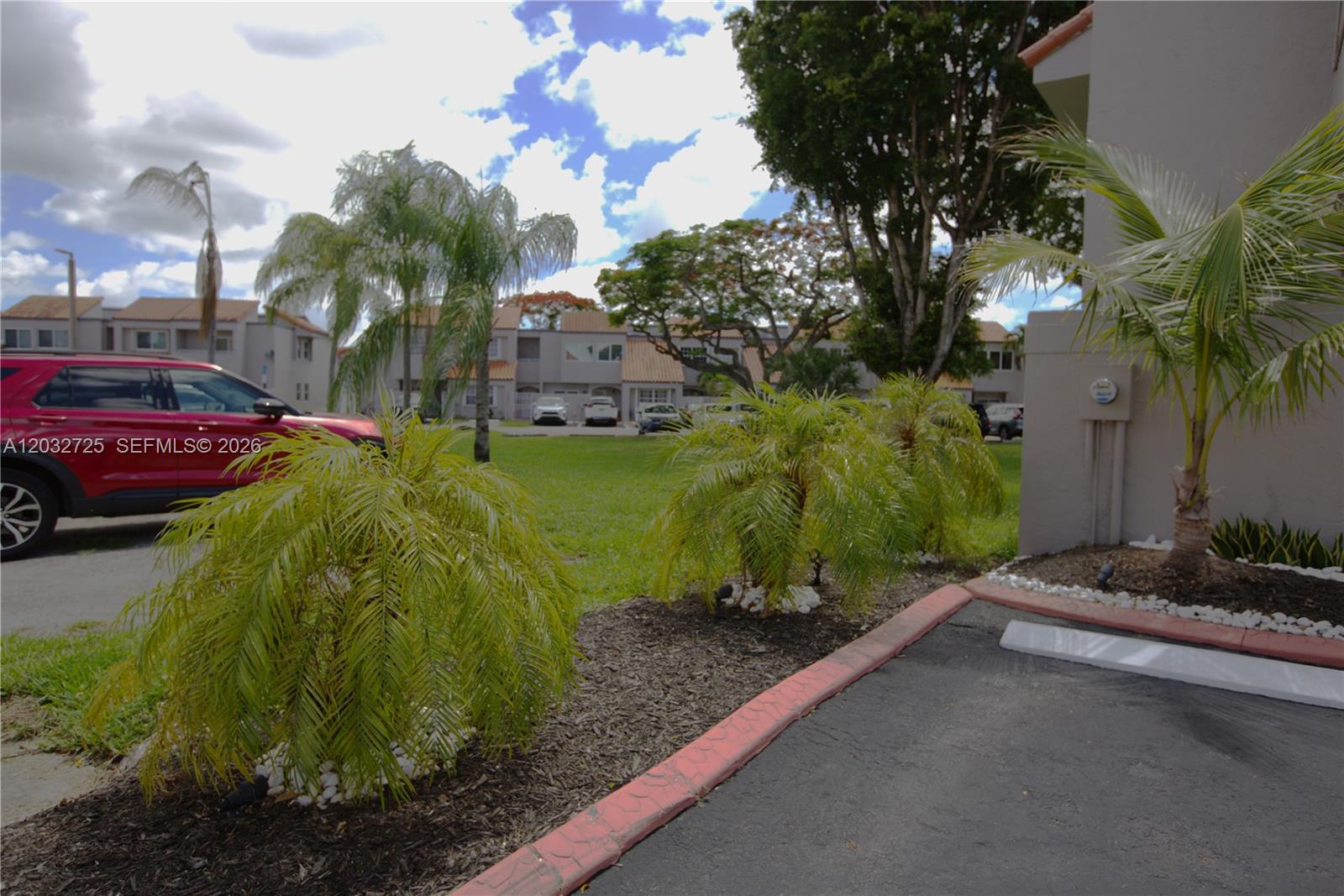 A beige two-story townhouse exterior features a palm tree, a stone walkway, and an ADT sign — 6475 SW 129th Ave, Miami FL 33183, MIAMI, FL
