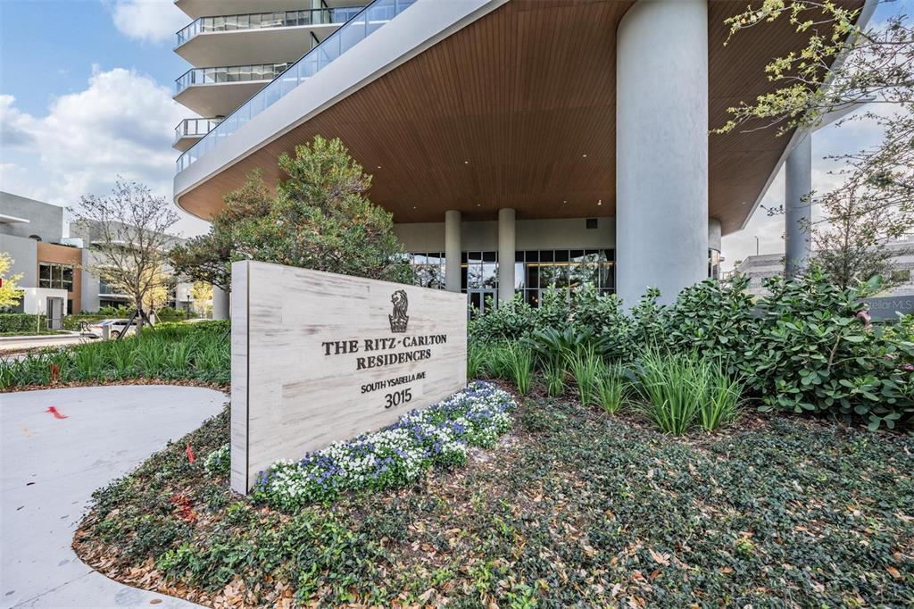 A sign for The Ritz-Carlton Residences stands in front of a modern high-rise building — 3015 S YSABELLA AVENUE UNIT 2003, TAMPA, FL