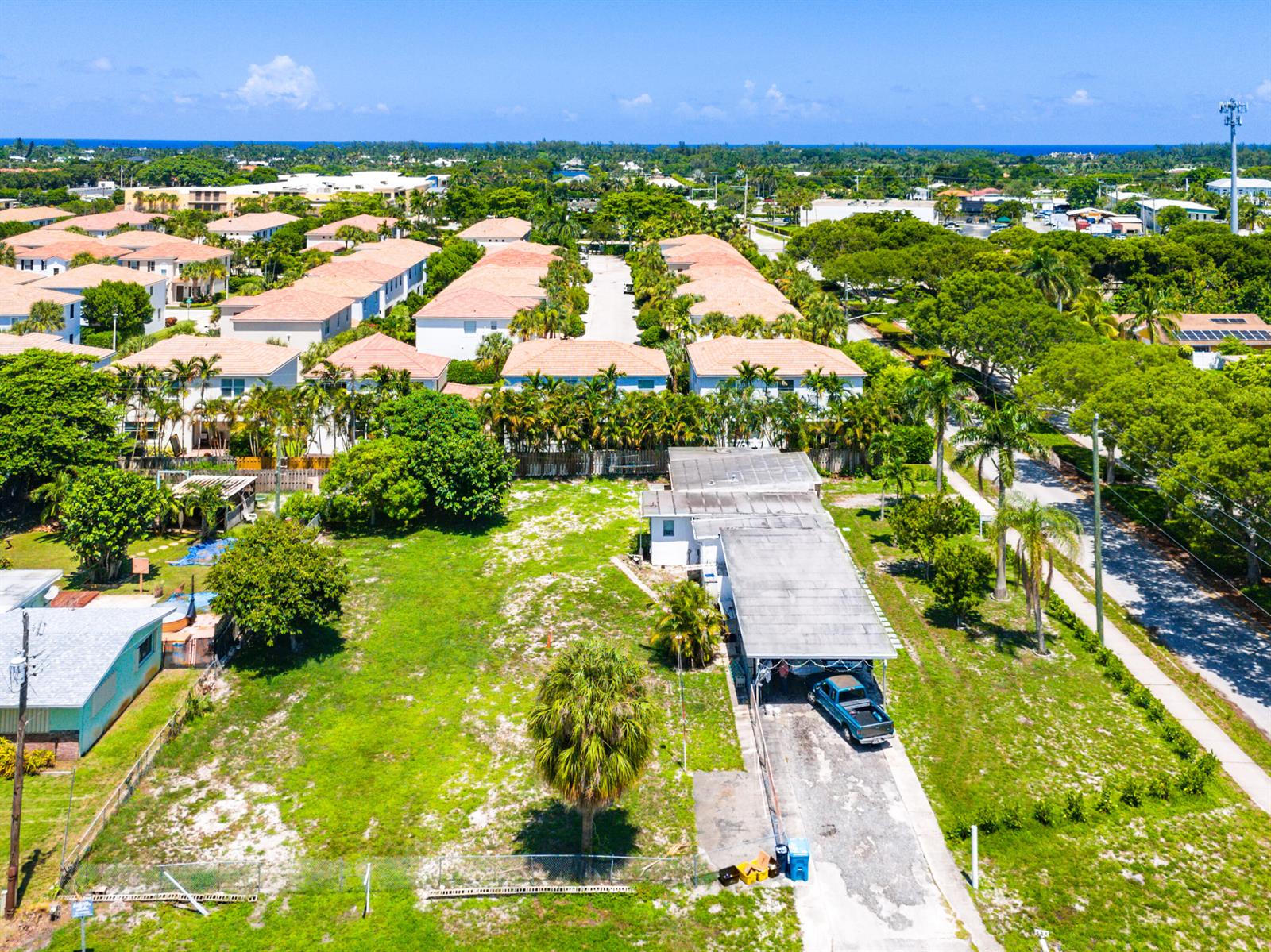 An aerial view shows a single-story house with a carport and a large grassy yard — 335 Gulfstream Boulevard, Boynton Beach FL 33435, BOYNTON BEACH, FL