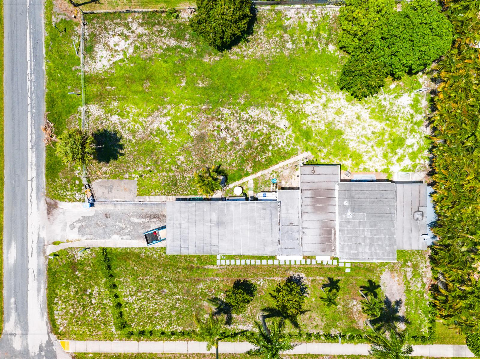 An aerial view shows a house with a flat roof on a large, grassy lot — 335 Gulfstream Boulevard, Boynton Beach FL 33435, BOYNTON BEACH, FL