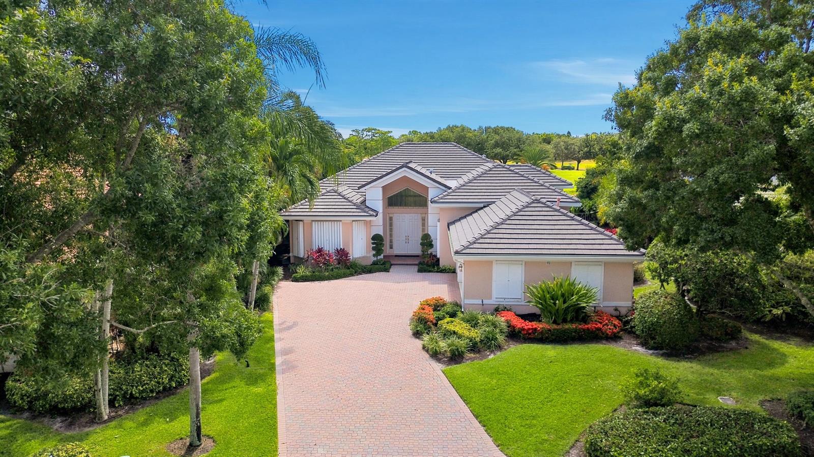 An aerial view of a single-story house with a tiled roof and a brick driveway — 173 N Village Way, Jupiter FL 33458, JUPITER, FL