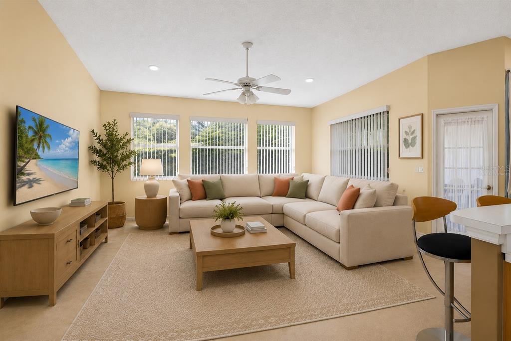 A living room features a beige sectional sofa, a wooden coffee table, and a television — 5157 39TH STREET W, BRADENTON, FL