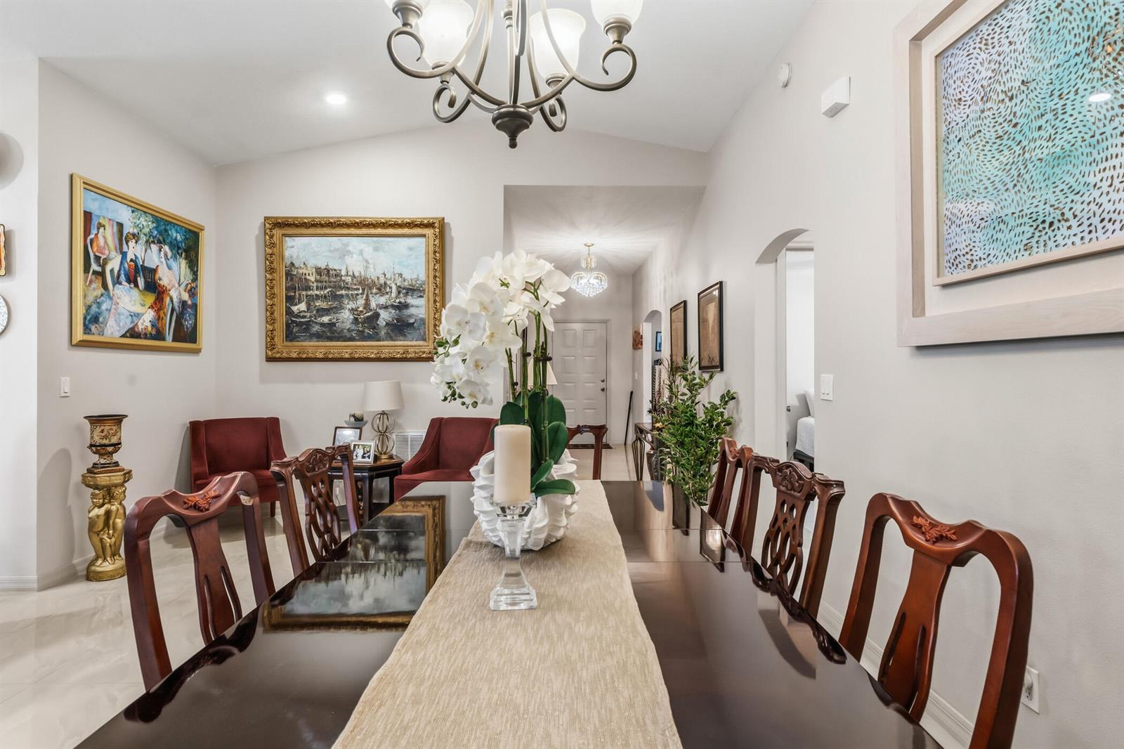 A dining room features a long dark wood table, ornate chairs, and a chandelier — 1013 E 13th Square, Vero Beach FL 32960, VERO BEACH, FL