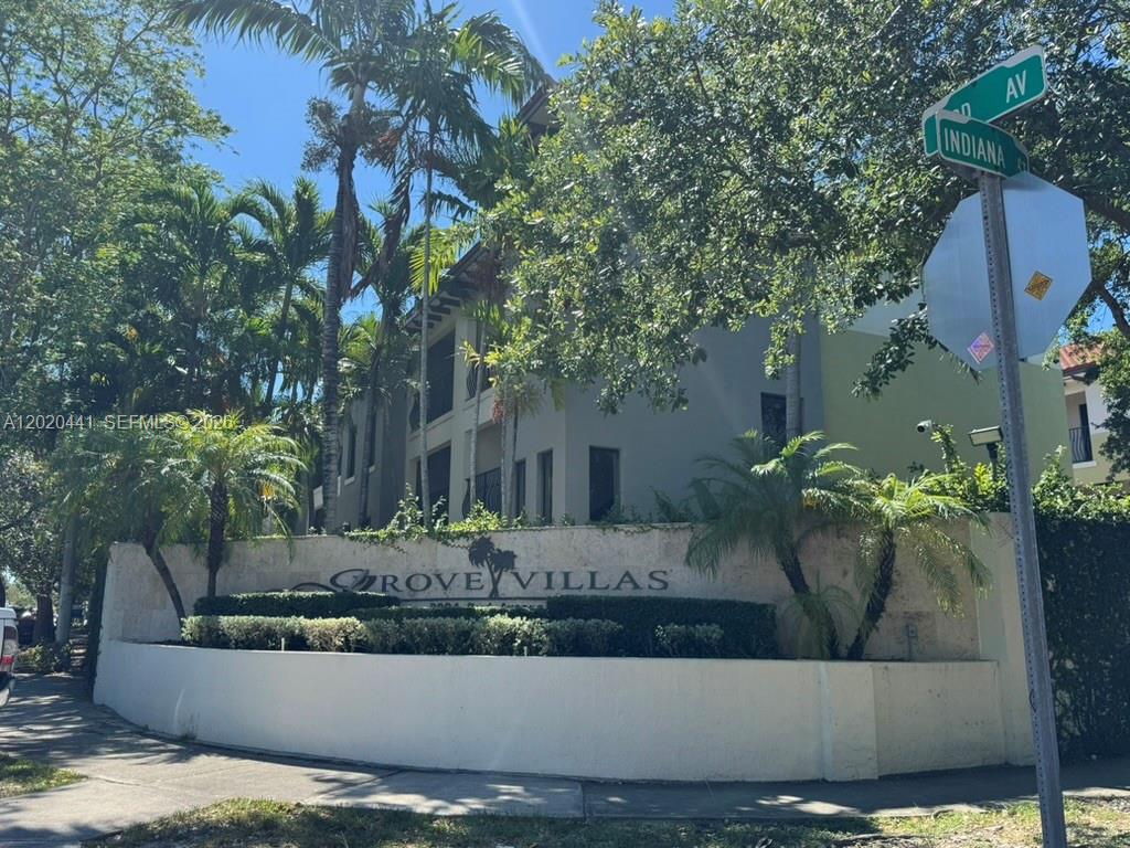 A stone monument sign for Grove Villas stands in front of a multi-story apartment building — 3204 Bird Ave # 104, Miami FL 33133, MIAMI, FL