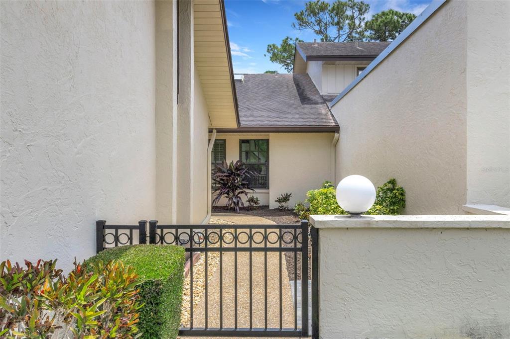 An aerial view shows a residential complex situated alongside a golf course and water — 4418 LA JOLLA DRIVE, BRADENTON, FL
