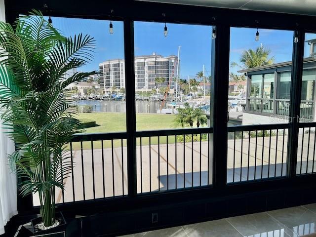 A view of a marina and buildings from a screened-in porch with a potted palm — 3250 SOUTHSHORE DRIVE UNIT 54-B, PUNTA GORDA, FL