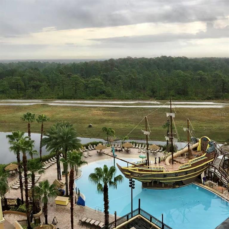 An elevated view shows a swimming pool with a large pirate ship play structure — 8125 RESORT VILLAGE DRIVE UNIT 5808, ORLANDO, FL