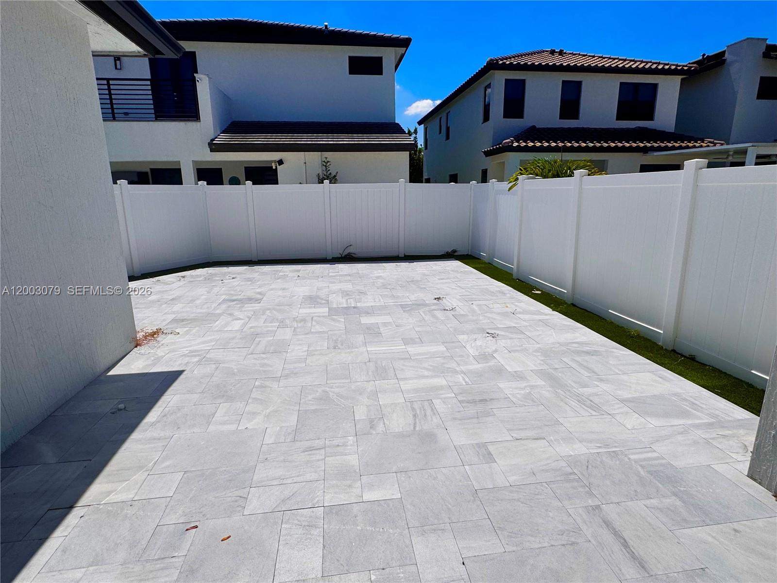 A paved patio area is enclosed by a white vinyl privacy fence — 8108 NW 48th Ter # 8108, Doral FL 33166, DORAL, FL