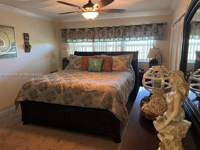 A bedroom features a dark wood bed frame, a ceiling fan, and a mermaid statue — 2901 S Palm Aire Dr # 603, Pompano Beach FL 33069, POMPANO BEACH, FL