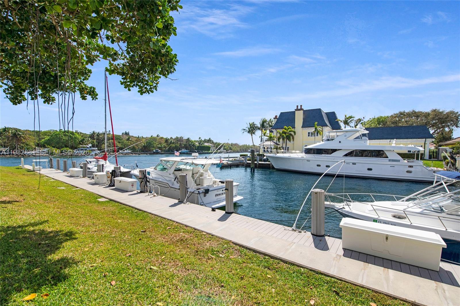 A view of a boat dock with several yachts moored along a canal — 3050 NE 48th Ct # 401, Lighthouse Point FL 33064, LIGHTHOUSE POINT, FL