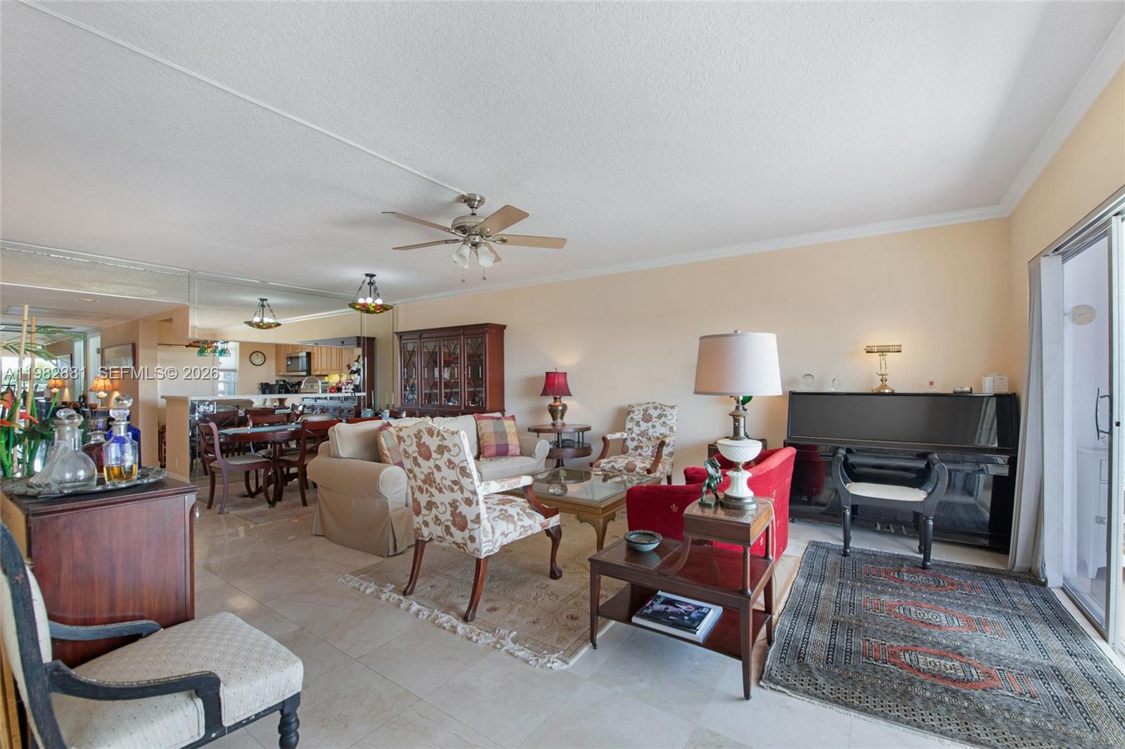 A living room features tile floors, a piano, a ceiling fan, and an adjacent dining area — 3050 NE 48th Ct # 401, Lighthouse Point FL 33064, LIGHTHOUSE POINT, FL