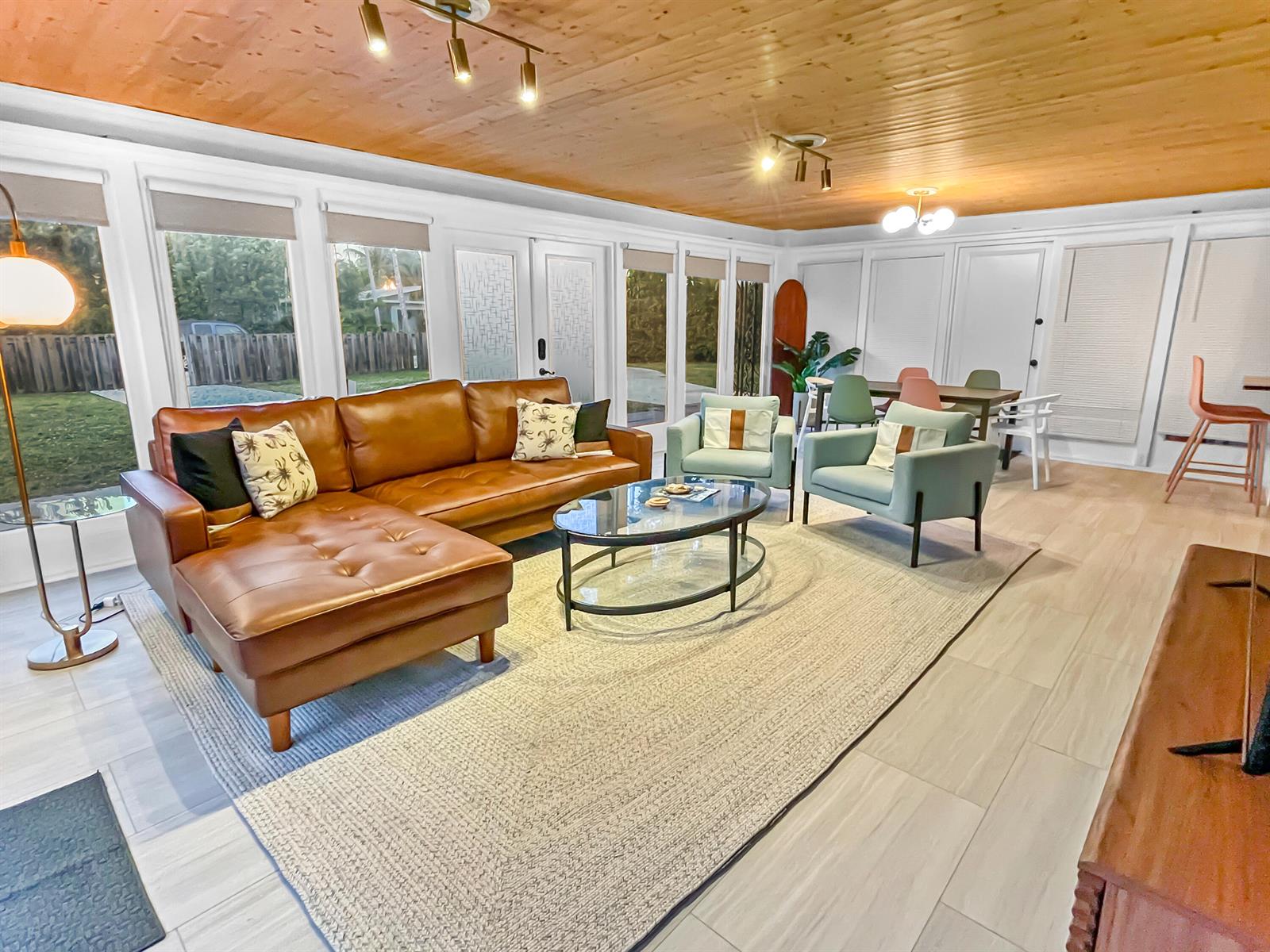 A living room features a leather sectional, light blue armchairs, and a wood-paneled ceiling — 1114 N M Street, FL 33460, FL