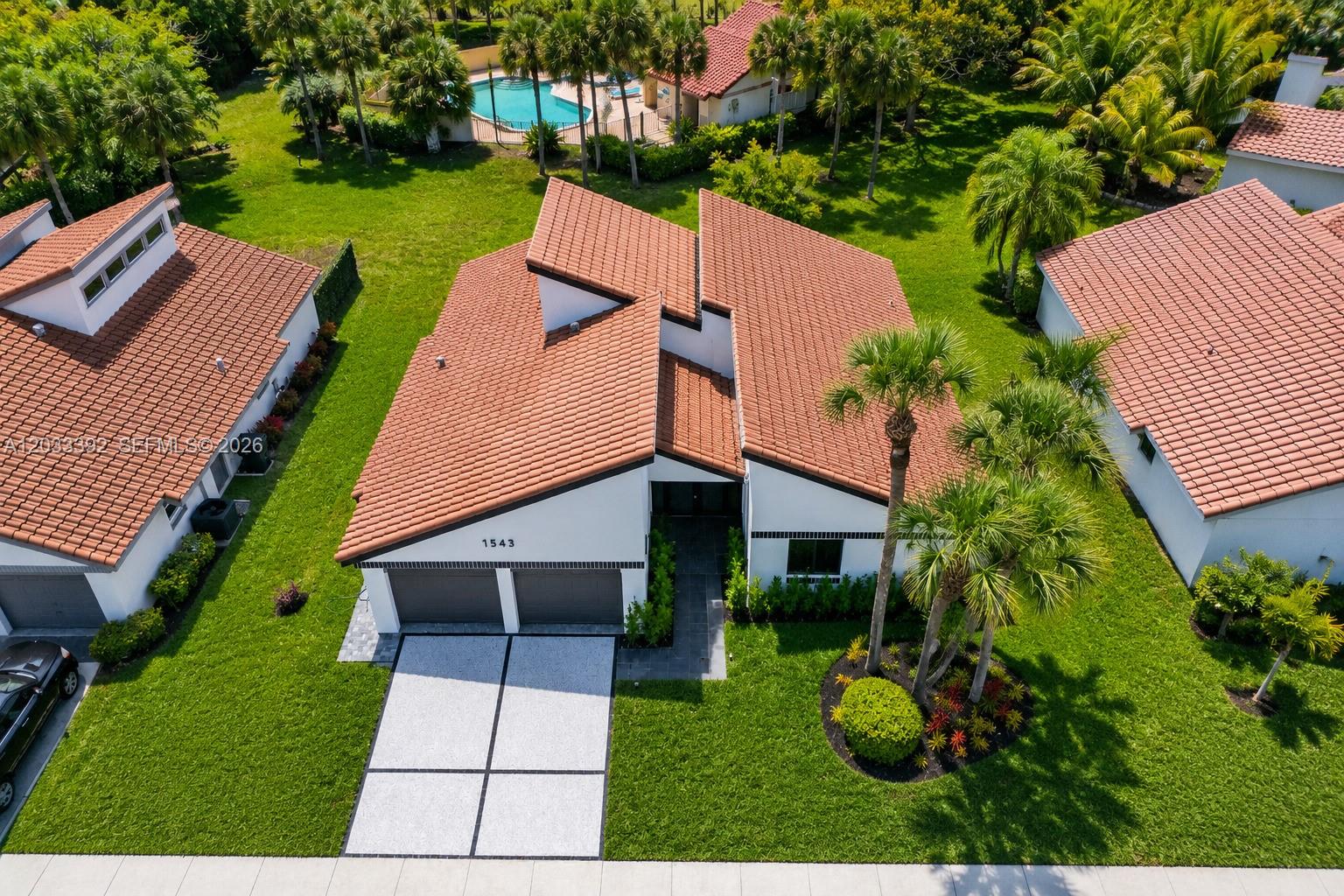 An aerial view shows a white house with a terracotta tile roof and two-car garage — 1543 SW 1st Ave, Boca Raton FL 33432, BOCA RATON, FL
