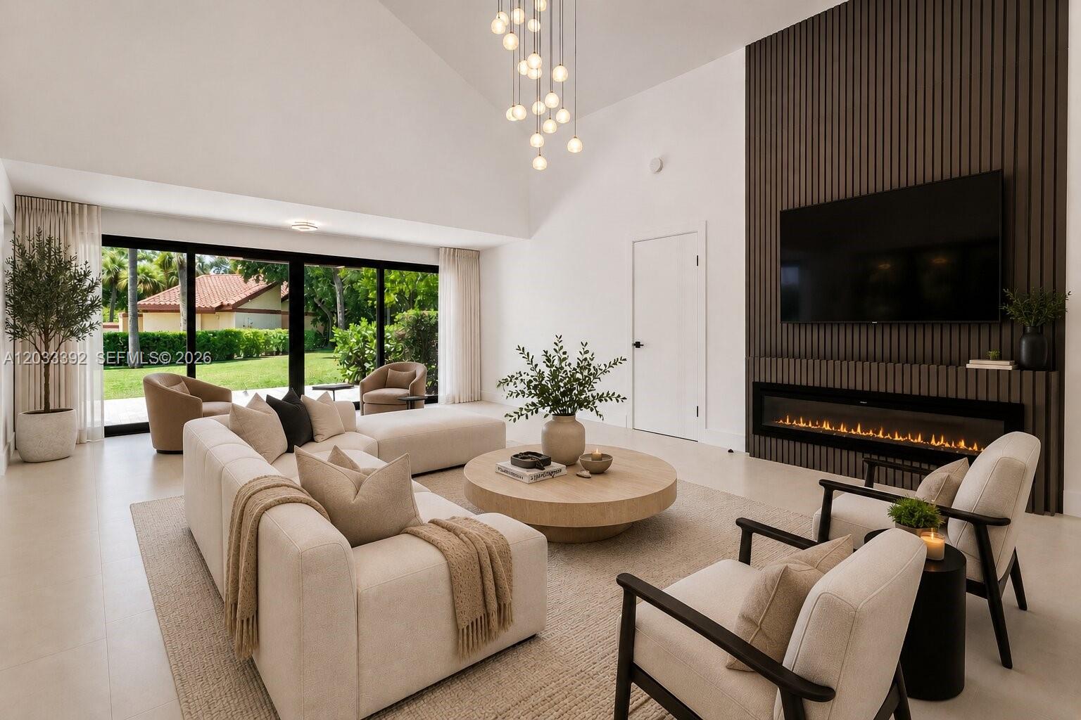 A modern living room features a fireplace, a large sectional, and floor-to-ceiling glass doors — 1543 SW 1st Ave, Boca Raton FL 33432, BOCA RATON, FL