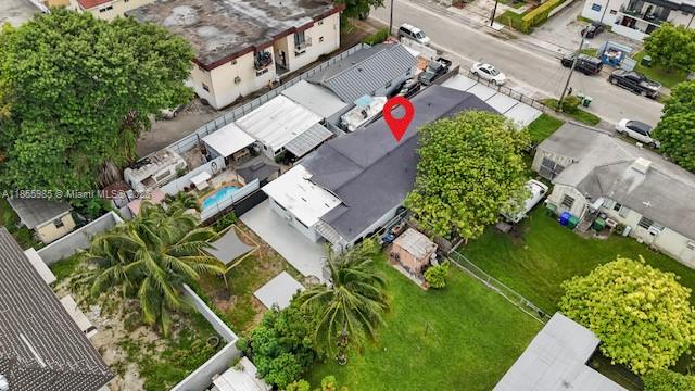 An aerial view shows a residential property with a dark-roofed house and a backyard — 3125 NW 21st Ct # 01, Miami FL 33142, MIAMI, FL
