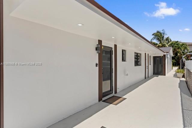 A white exterior wall features a dark-framed glass door and a small window — 3125 NW 21st Ct # 01, Miami FL 33142, MIAMI, FL